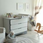 Beautiful baby room interior with toys, armchair and modern chan
