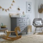 Beautiful baby room interior with toys, rocking chair and modern